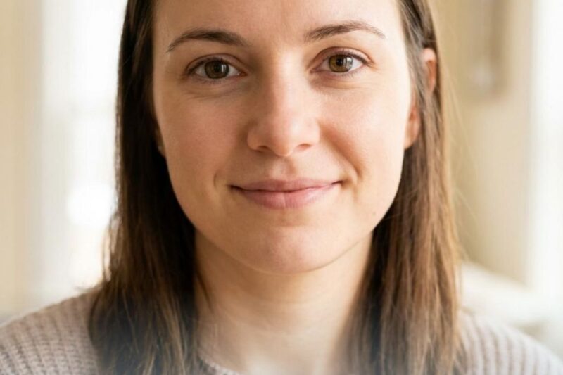 Woman smiling indoors, text about Juvederm.