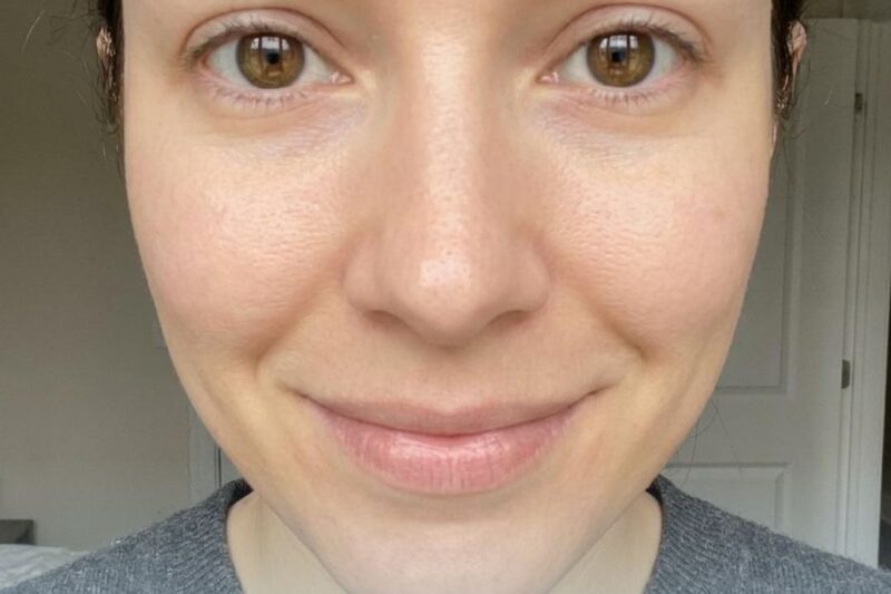 Smiling person with bright eyes, close-up.