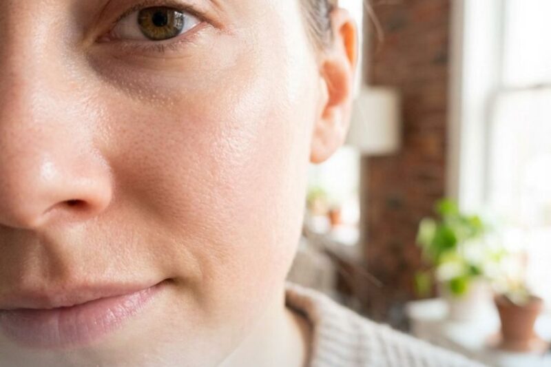 Close-up of woman's face with skincare text.