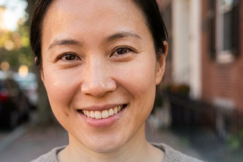 Smiling person promoting skin treatment service.