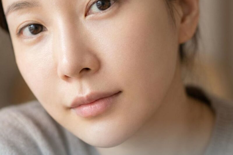 Woman with smooth skin, promoting laser treatment.